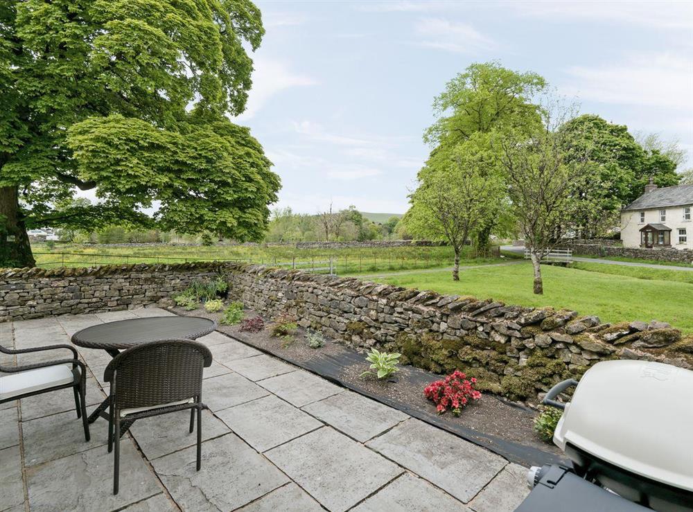 Enclosed patio area with garden furniture at Beckside Cottage in Orton, near Appleby, Cumbria