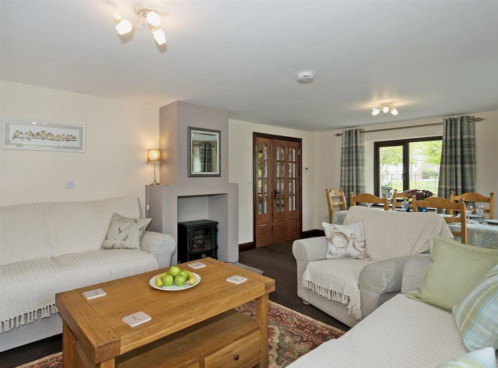 Spacious living room/dining room with woodburner at Beckside Cottage in Orton, near Appleby, Cumbria