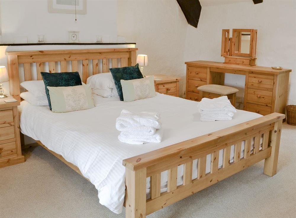 Double bedroom with beamed ceiling at Bee Bowl Cottage in Landcross, near Bideford, Devon