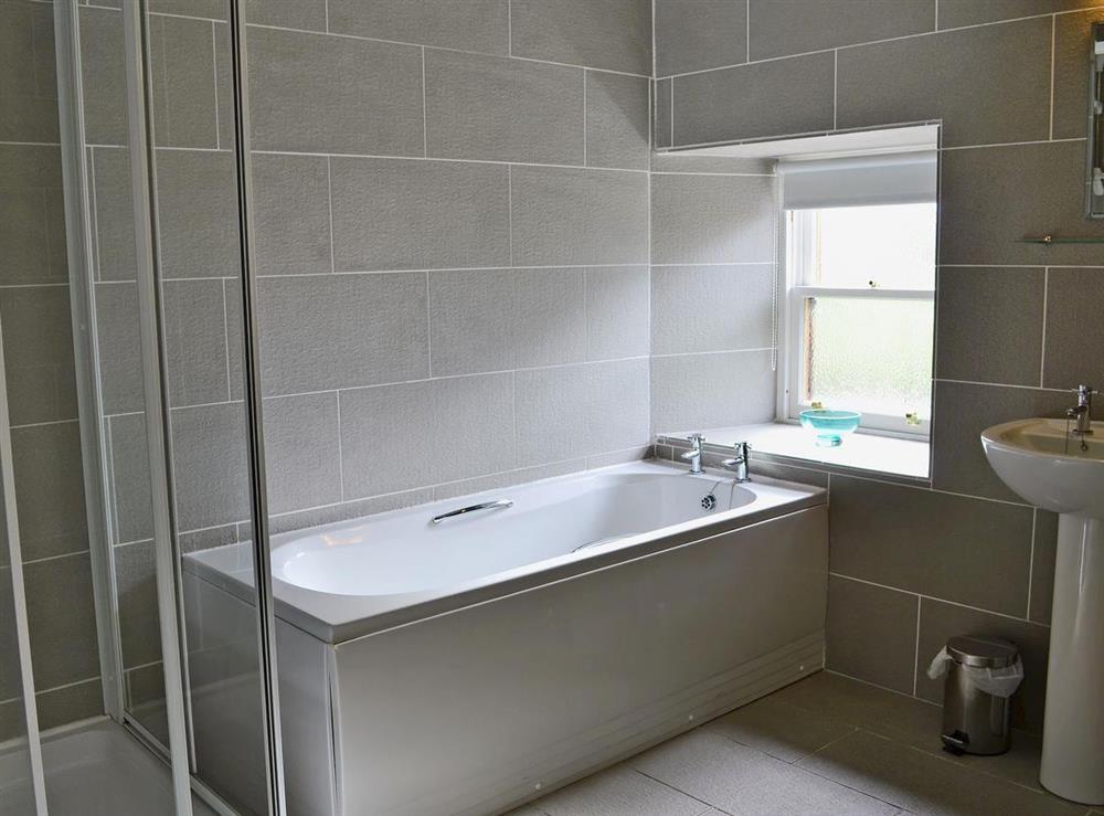 Fully tiled bathroom with separate shower cubicle and toilet at Beech Cottage in Crawfordjohn, Nr Biggar, S. Lanarkshire., Great Britain