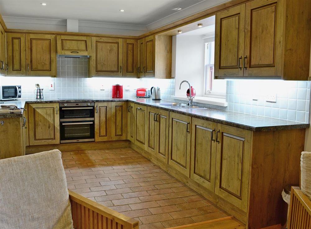 Large well-equipped kitchen with tiled floor at Beech Cottage in Crawfordjohn, Nr Biggar, S. Lanarkshire., Great Britain