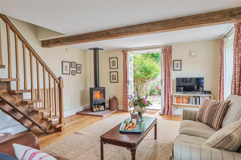 Relax in the cosy sitting room complete with wood burning stove at Beech Cottage, Honiton