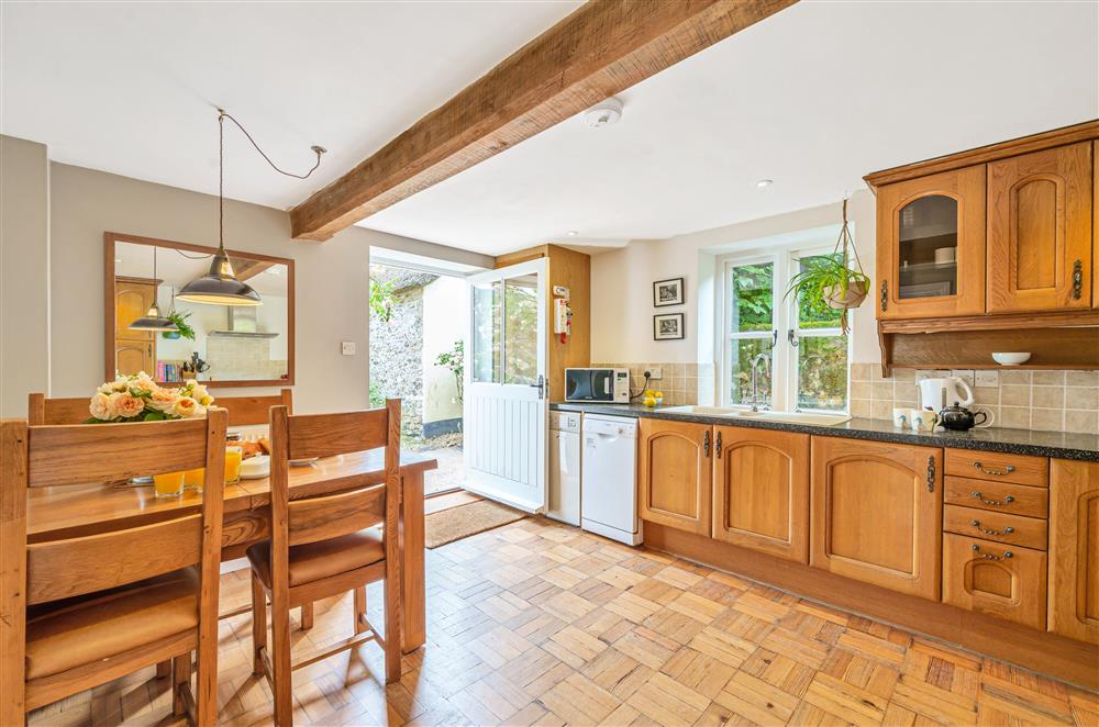 The open-plan kitchen and dining area with plenty of space for meal preparation at Beech Cottage, Honiton
