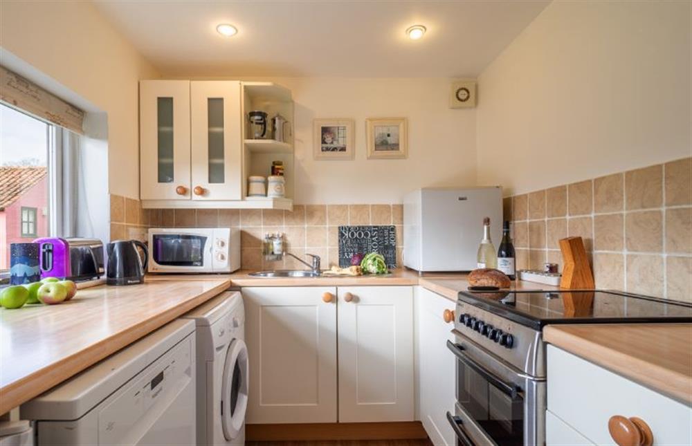 Kitchen with electric hob and oven, microwave and dishwasher at Beech Cottage, Westleton