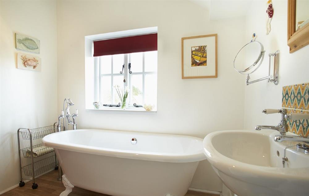 Bathroom with a roll top bath and shower attachment at Beech End, Plumstead