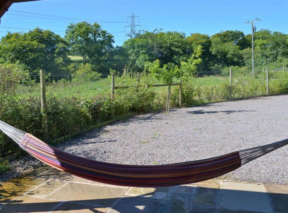 Relax and take in the view from the comfortable hammock at Beer Farm in Waterrow, near Wiveliscombe, Somerset., Great Britain