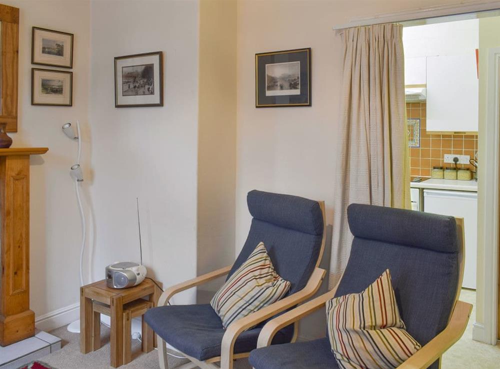 Living room with easy access to the kitchen at Begbie Cottage in Bowness-on-Windermere, Cumbria