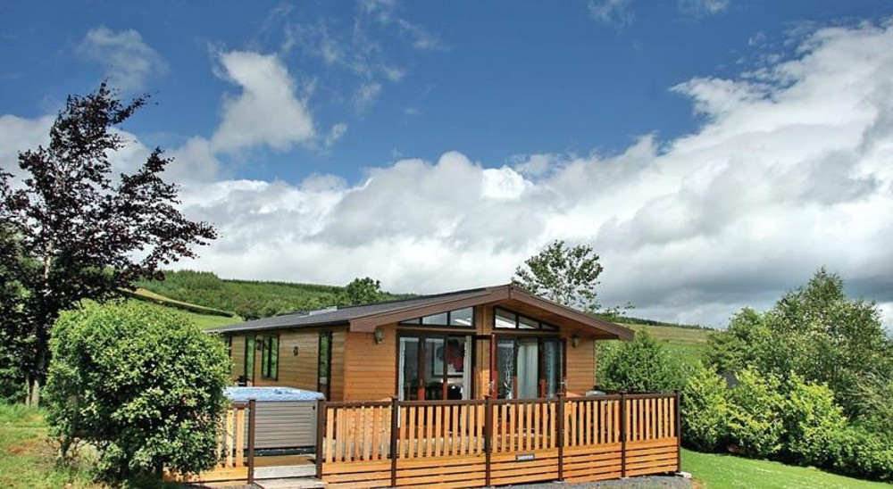 Lodge and hot tub at Belan Bach Lodges in Powys, Wales