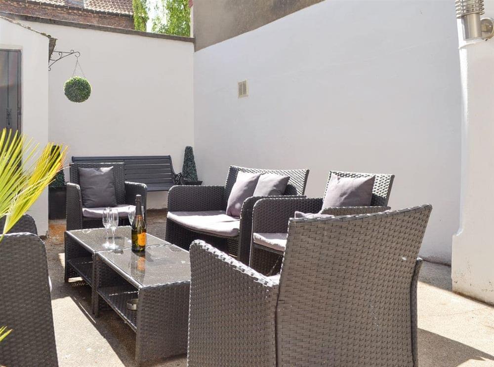 Enclosed courtyard with outdoor furniture at Belfrey House in York, North Yorkshire