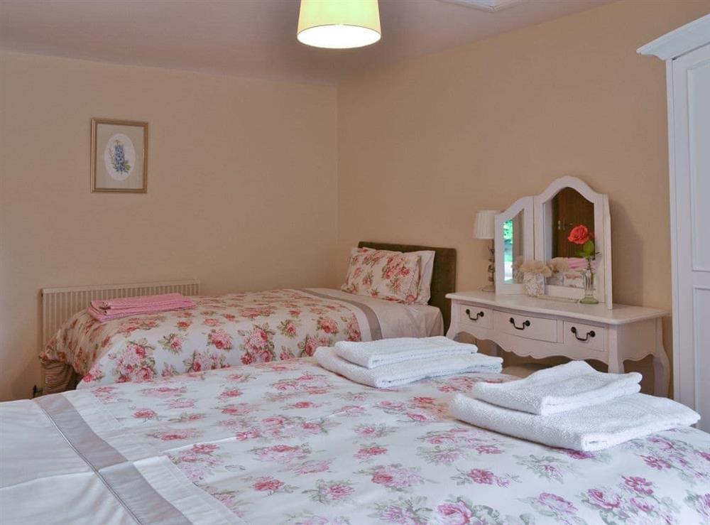 Family bedroom with a double and a single bed at Bellegrove Cottage in Watermillock, Ullswater, Cumbria
