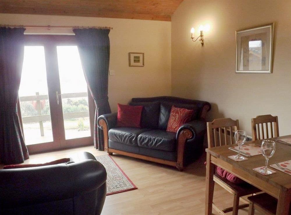 Living room with French doors at Ben Alder Lodge in Campsie Fells, near Milton of Campsie, Lanarkshire
