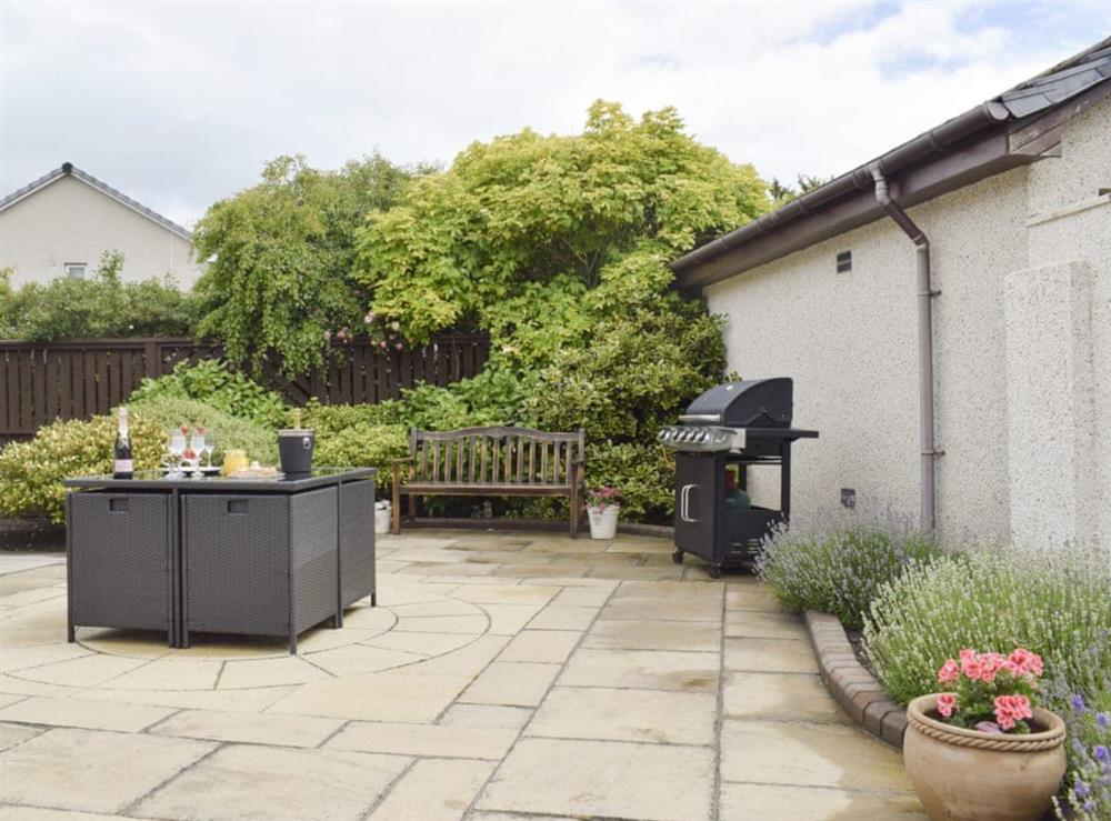 Paved patio with BBQ and outdoor furniture at Ben The Hoose in Anstruther, Fife, Scotland