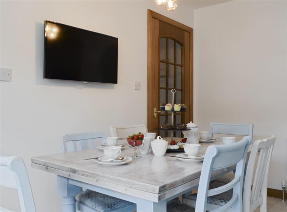Stylish dining area with wall mounted TV at Ben The Hoose in Anstruther, Fife, Scotland
