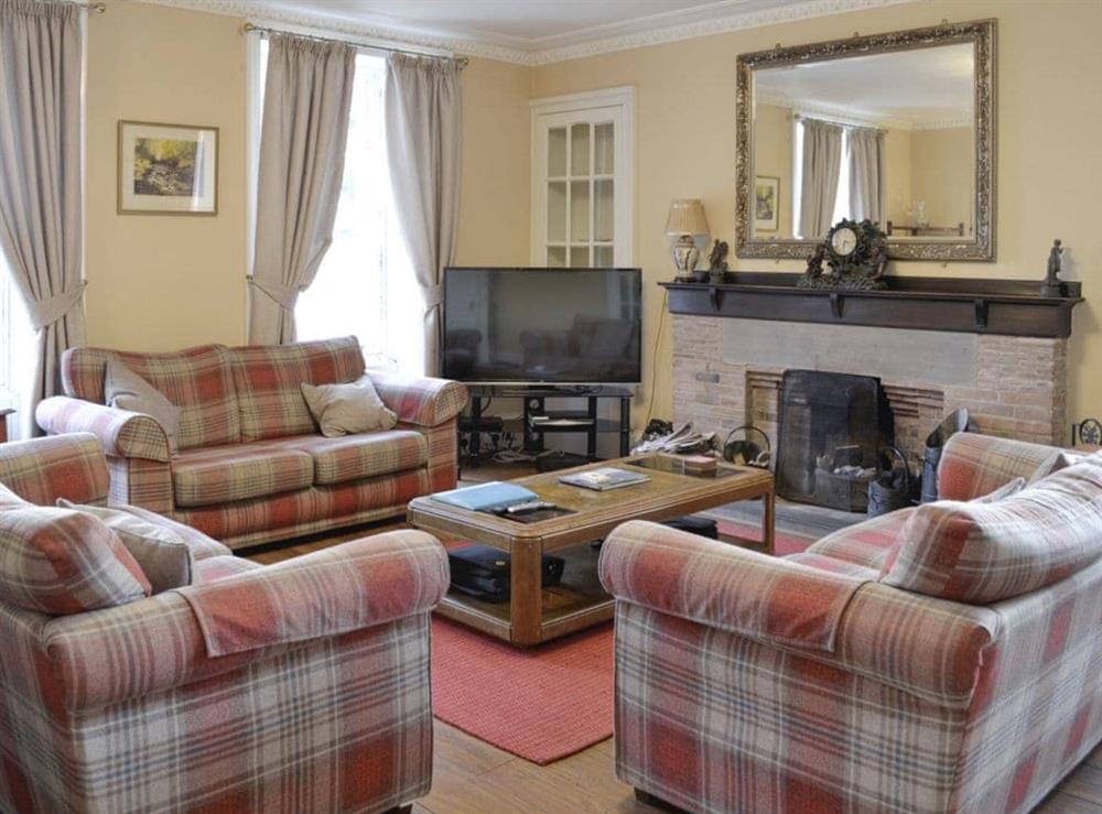 Warm and welcoming living room at Benvie Farmhouse in Invergowrie, near Dundee, Angus