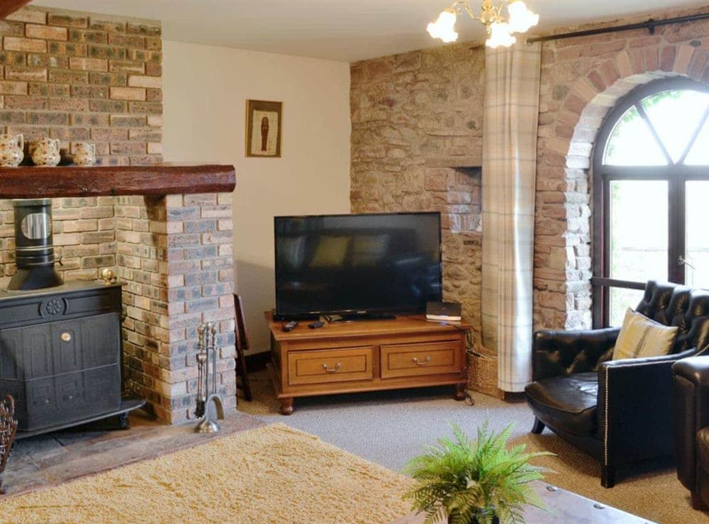 Comfortable living room with cosy wood burner at Berwyn Bank in Arkleby, near Cockermouth, Cumbria