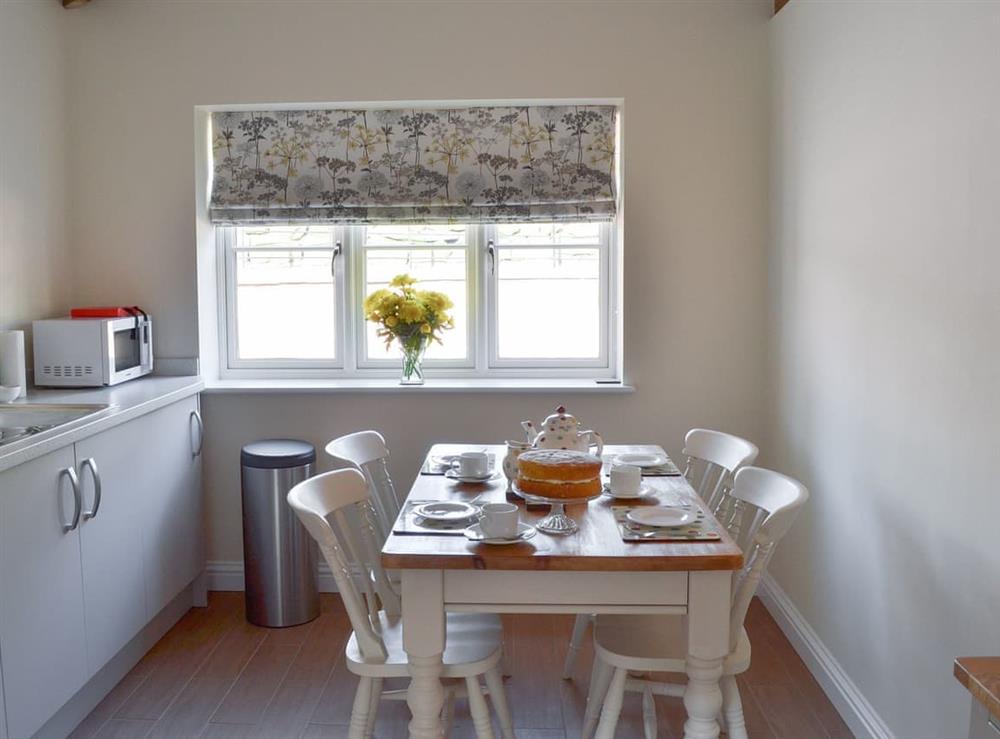 Kitchen with dining area at Woodside Cottage, 
