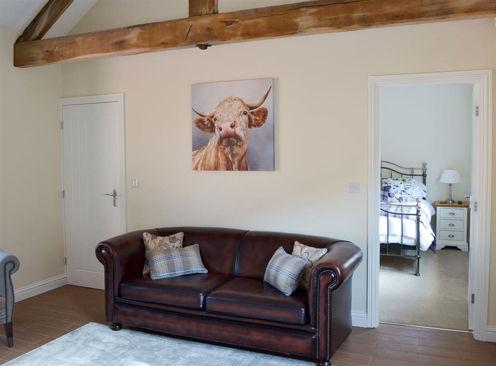 Living room with exposed wooden beams at Woodside Cottage, 