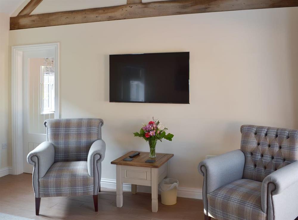 Living room with wall mounted TV (photo 2) at Woodside Cottage, 