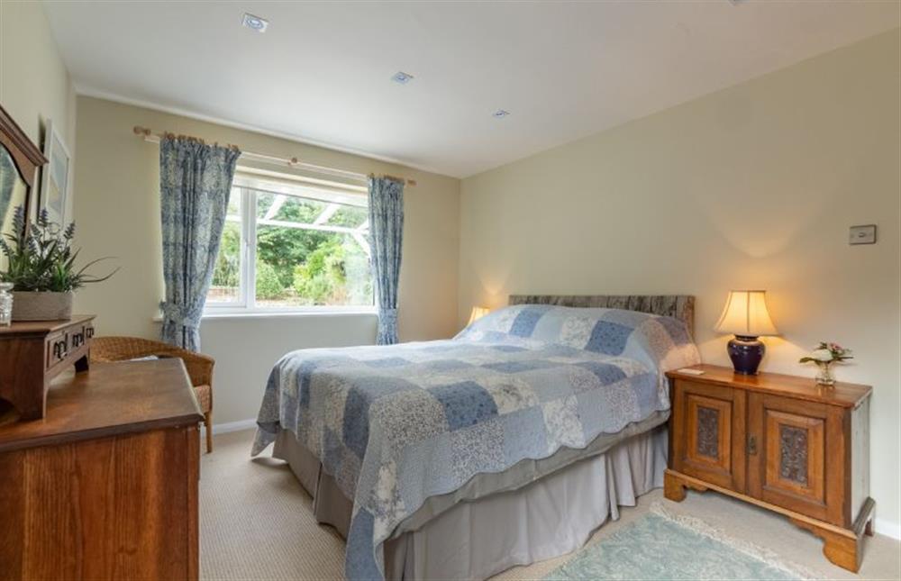 Ground floor: Bedroom two with king-size bed at Bettys Cottage, Brancaster near Kings Lynn