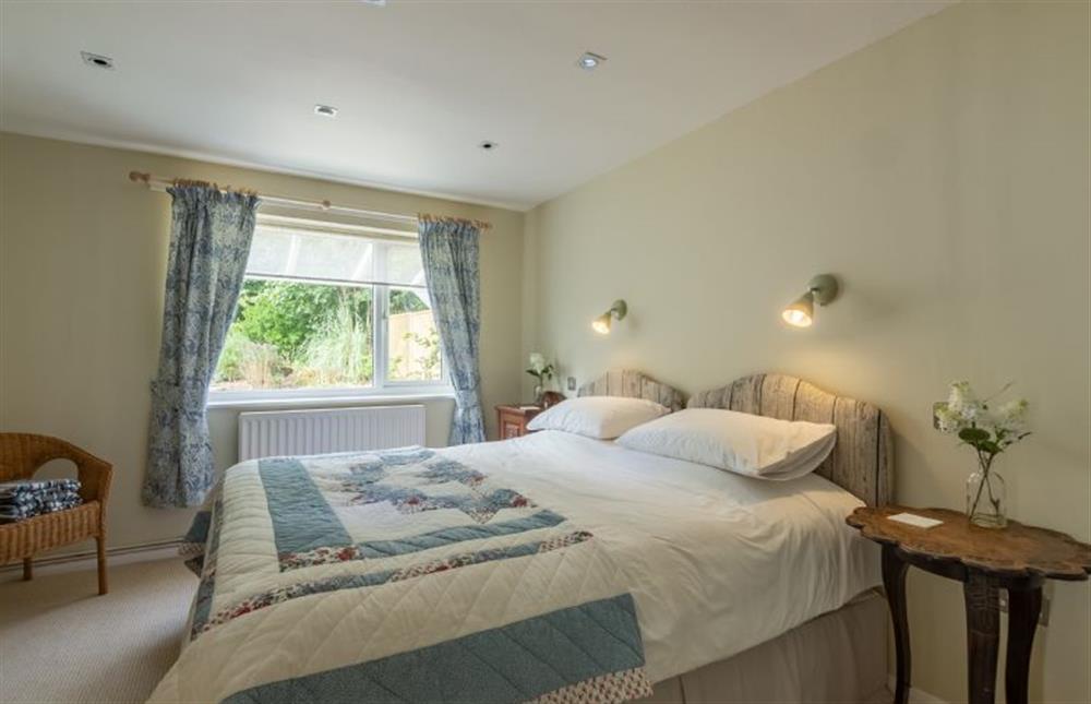 Ground floor: Master bedroom has a super-king zip and link bed at Bettys Cottage, Brancaster near Kings Lynn