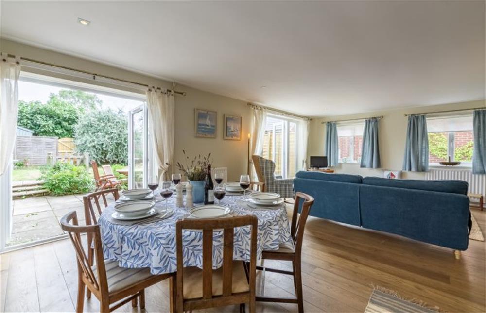 Ground floor: Open-plan dining/sitting room with french doors leading out into the garden at Bettys Cottage, Brancaster near Kings Lynn