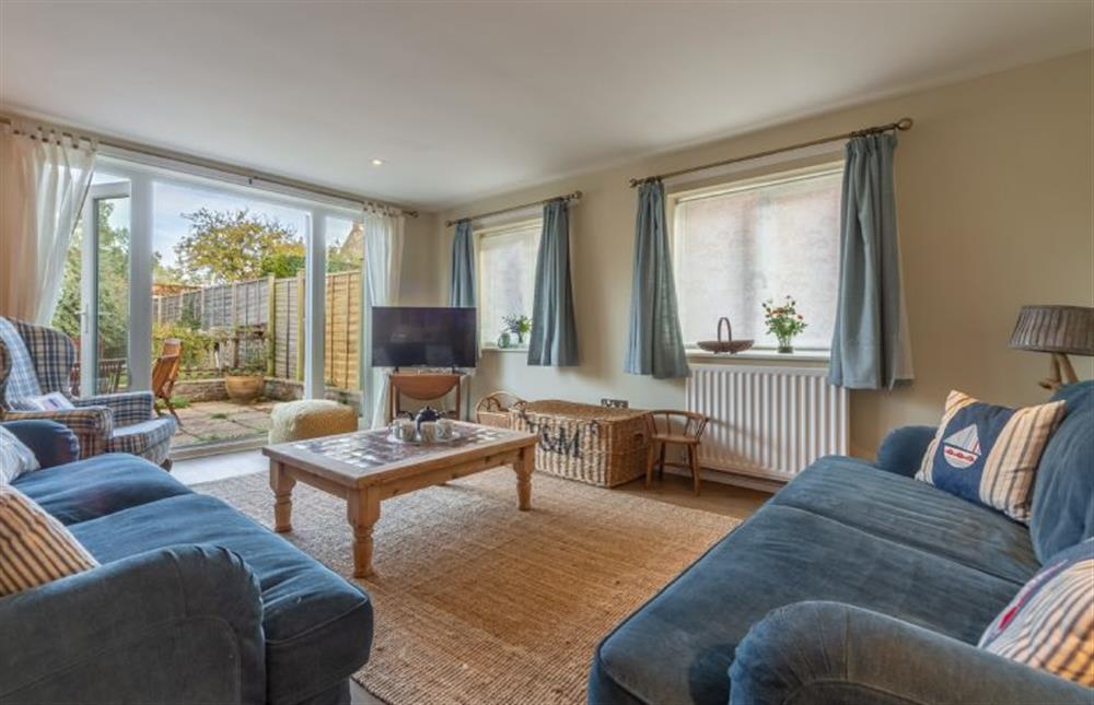 Ground floor: Sitting room with french doors leading out into the garden at Bettys Cottage, Brancaster near Kings Lynn