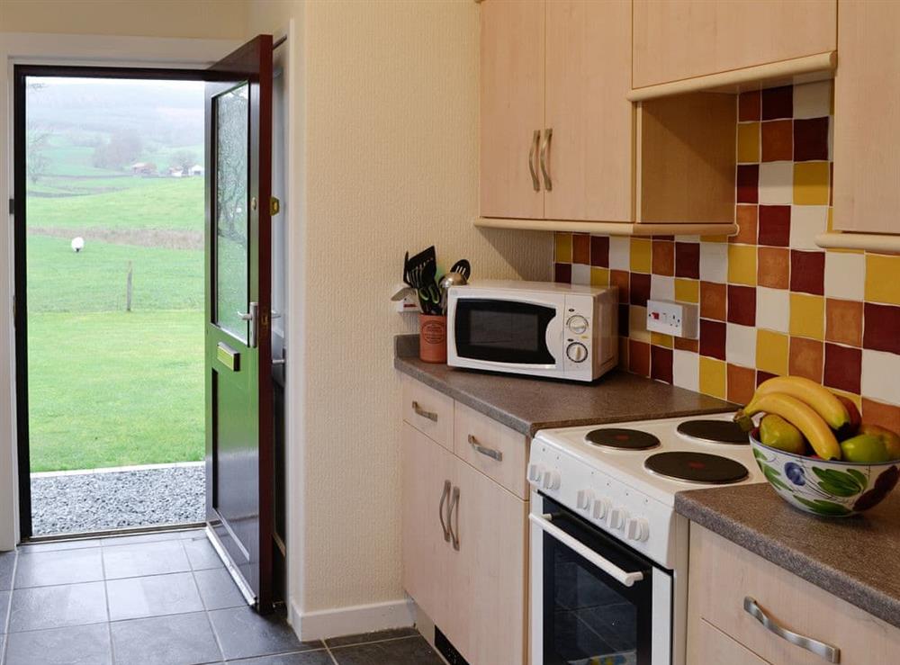 Fully appointed kitchen with access to garden at Beuchan Bungalow, 