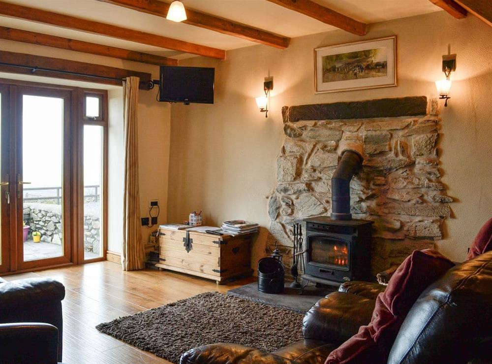 Cosy living room with wood burner at Beudy Bach in Cilgwyn, near Caernarfon, Gwynned, Gwynedd