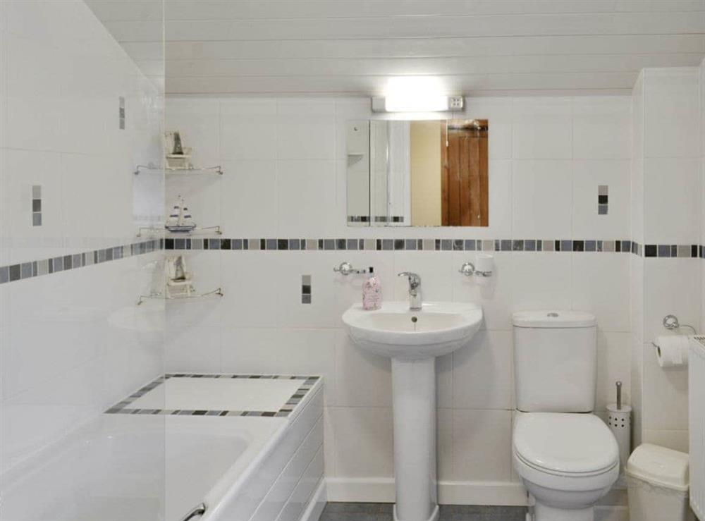 Downstairs family bathroom with shower over bath at Beudy Hen in Llanfair, near Harlech, Gwynedd