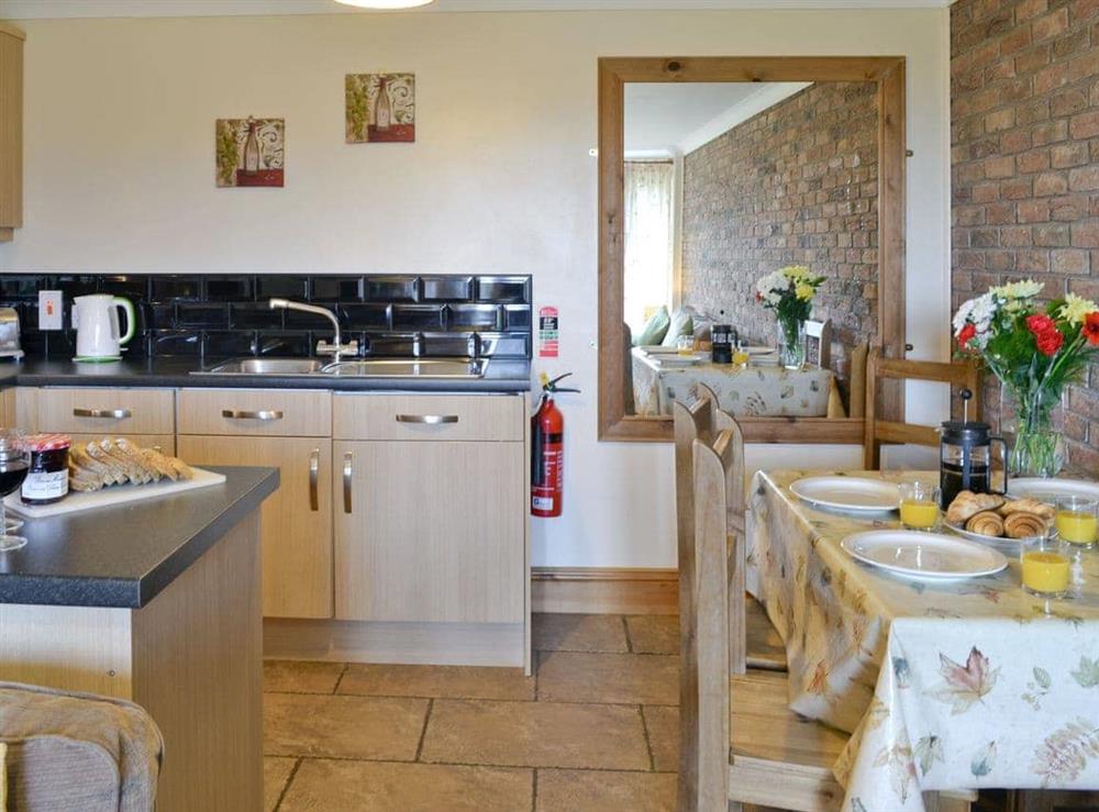 Comprehensively-equipped kitchen and dining area at Bevan Cottage in Muston, Filey, North Yorkshire