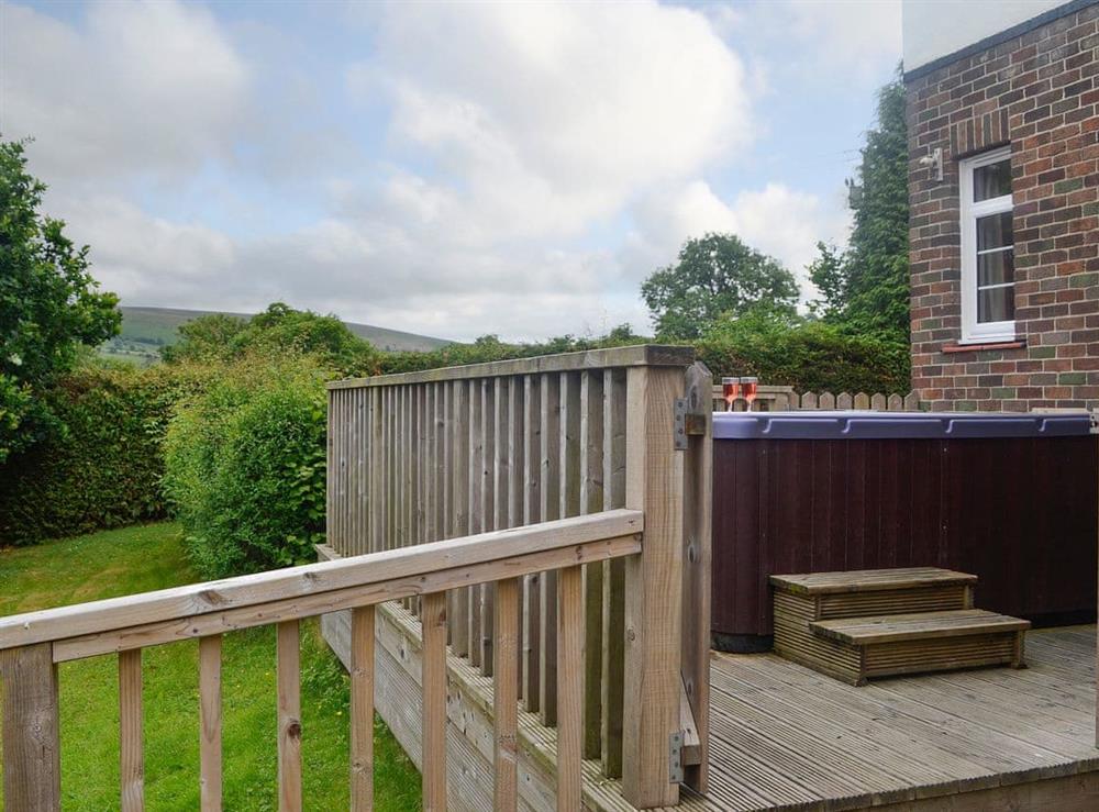 Elevated decked area with hot tub at Bevan House in Hundred House, near Builth Wells, Powys