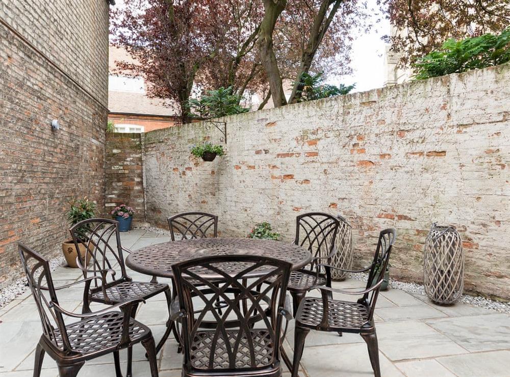 Enclosed courtyard with sitting-out area and garden furniture at Beverley Minster House in Beverley, North Humberside