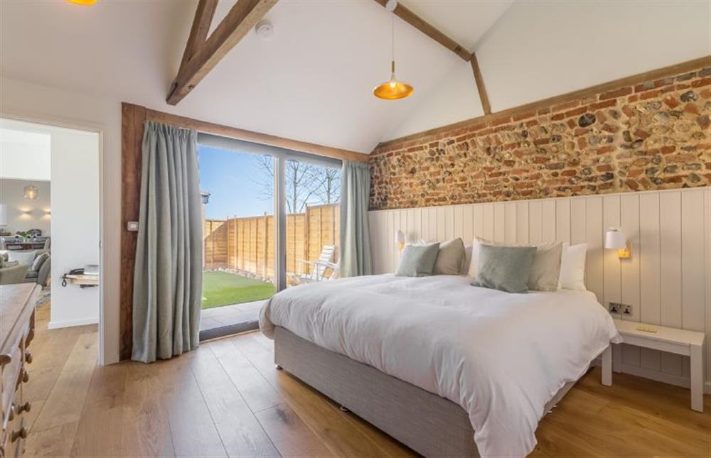 Ground floor:  Bedroom two with sliding door to enclosed courtyard at Big Sky Barn, Ridlington near Norwich