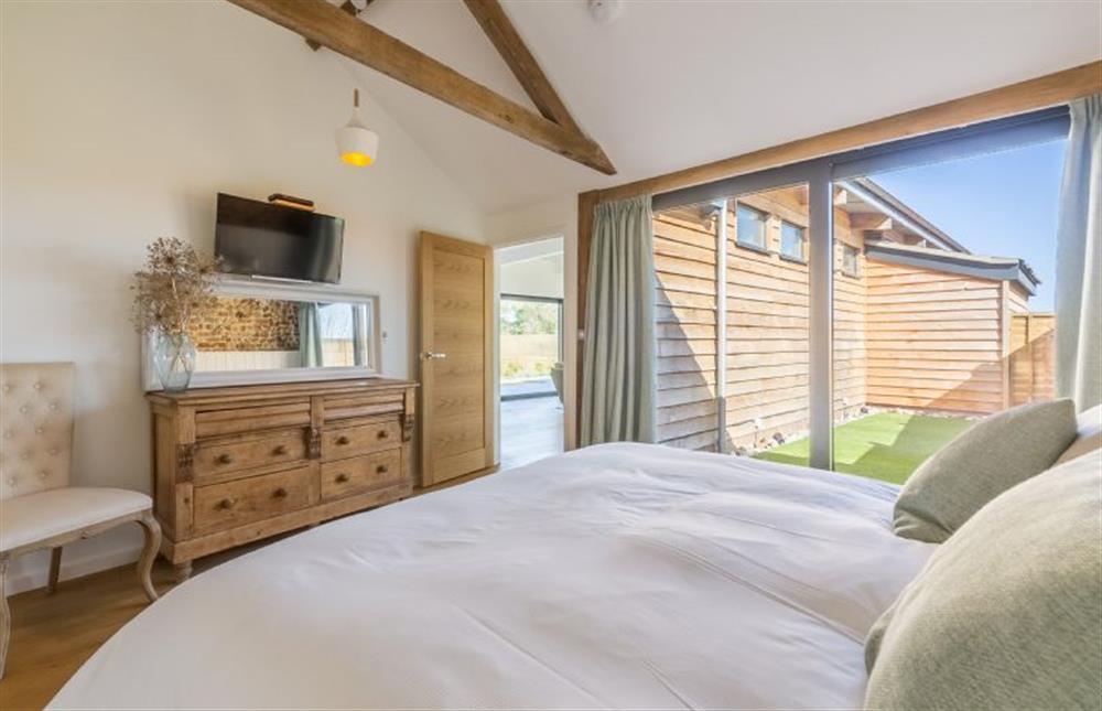 Ground floor:  Bedroom two with wall mounted flatscreen television at Big Sky Barn, Ridlington near Norwich