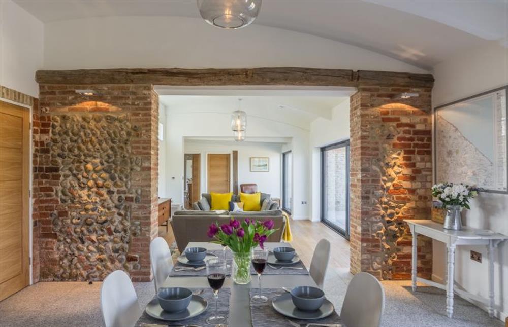 Ground floor:  Dining area with feature exposed brick wall at Big Sky Barn, Ridlington near Norwich