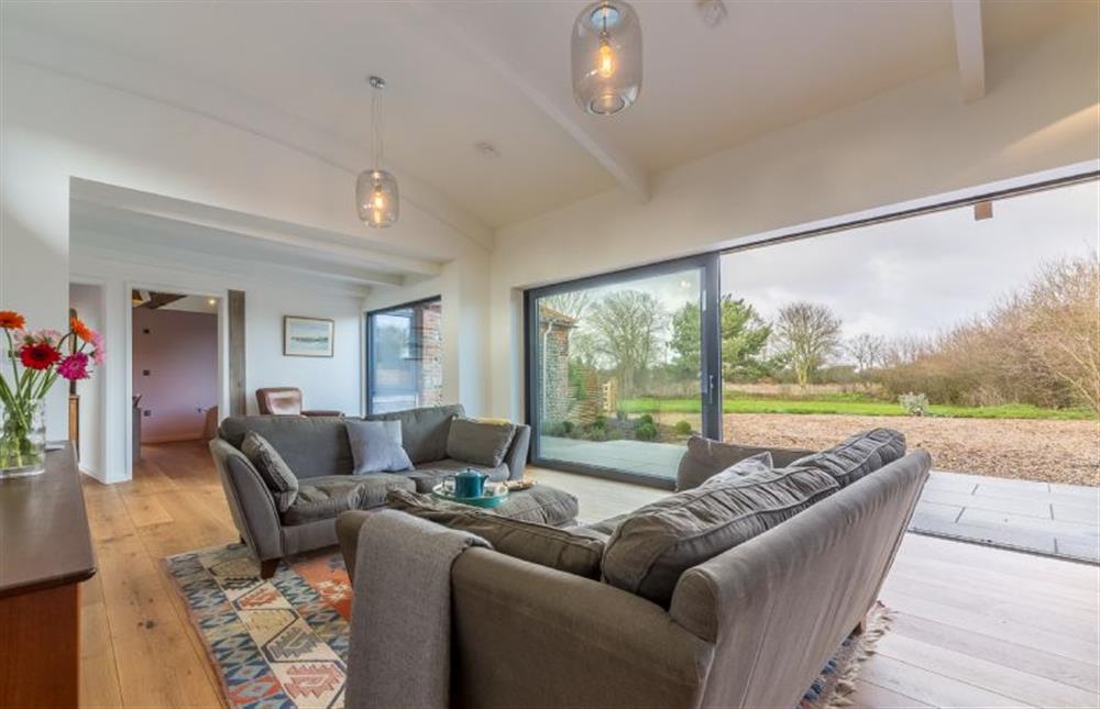 Ground floor:  Sitting area with sliding glass doors to courtyard at Big Sky Barn, Ridlington near Norwich