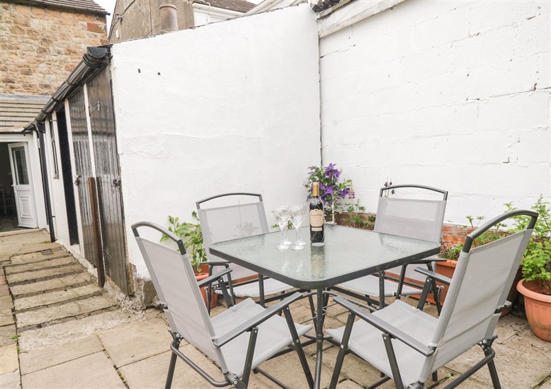 Enjoy a glass of wine on the patio at Billys Cottage, Dearham