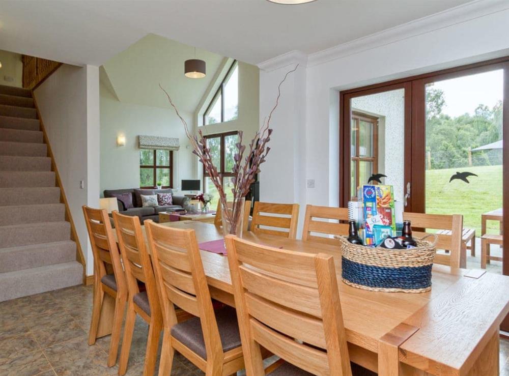 Dining area overlooking the pretty garden at Birch Corner in Aviemore, Inverness-Shire