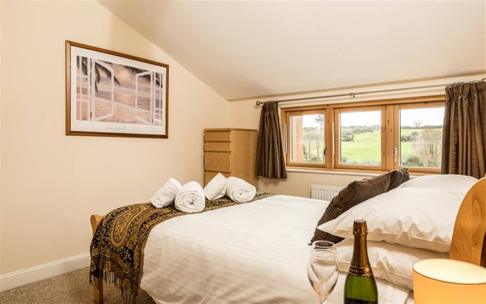 The master bedroom has gorgeous views across the countryside. at Birch Cottage in Falmouth