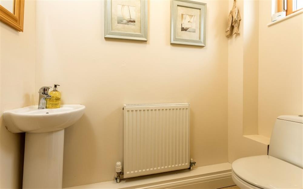 The prints on the wall look good in the family bathroom. at Birch Cottage in Falmouth