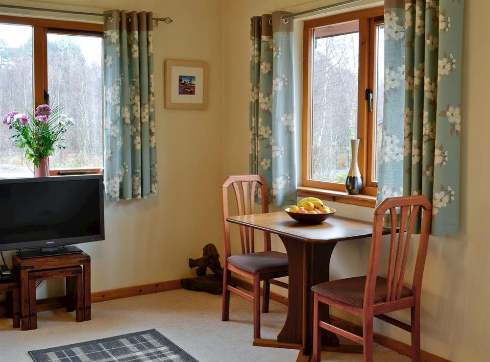 Lounge with dining table at Birch Lodge in Torcastle, near Fort William, Inverness-Shire