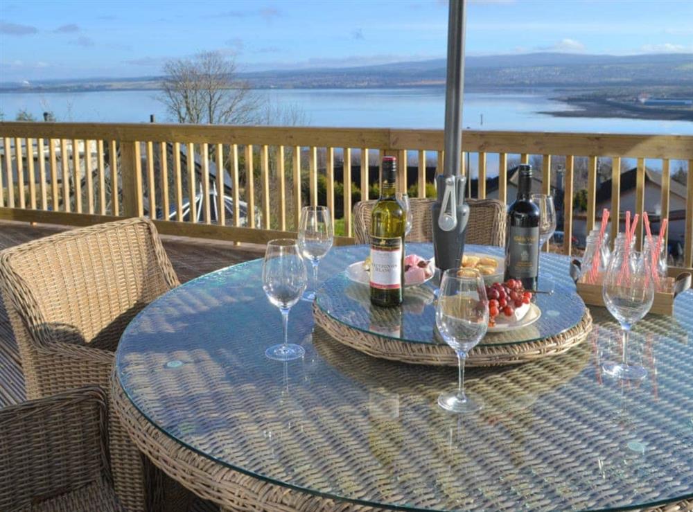 Outdoor dining area with wonderful waterside views at Birdsong in Craigton, near Inverness, Highlands, Inverness-Shire