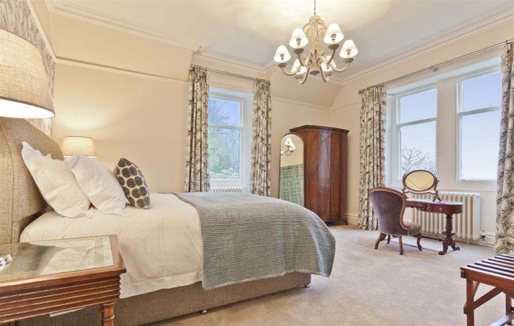 Bedroom with 6’ super king size bed and double aspect window at Birkdale House, Windermere
