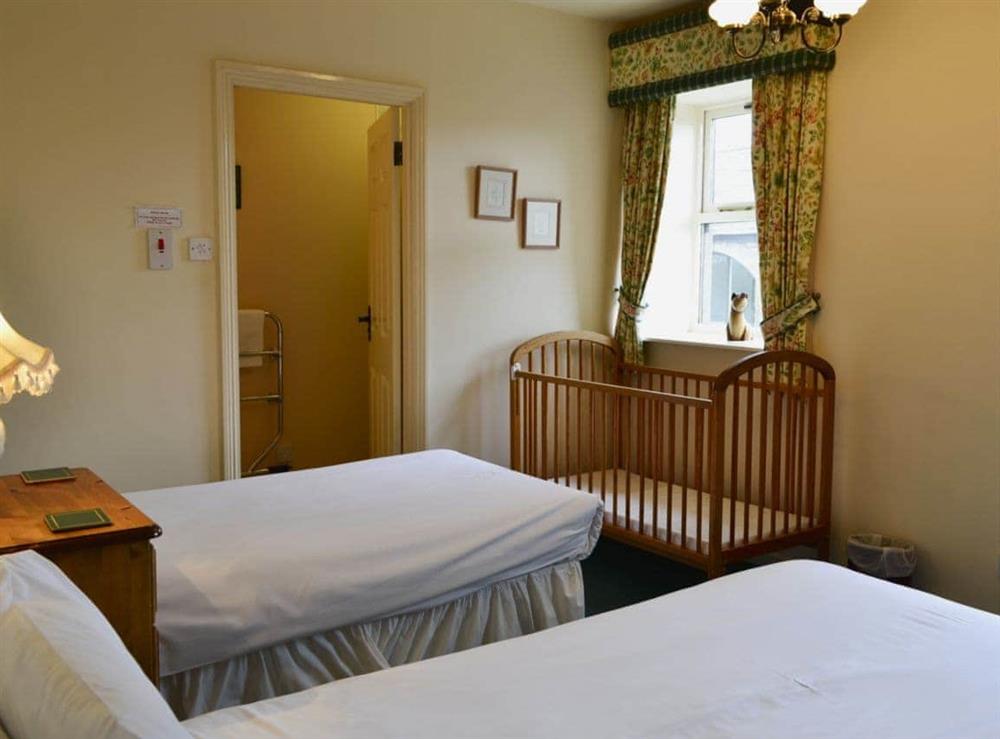 Twin bedroom with en-suite shower room at Bizzie Lizzie Cottage in Akeld, Wooler, Northumberland., Great Britain