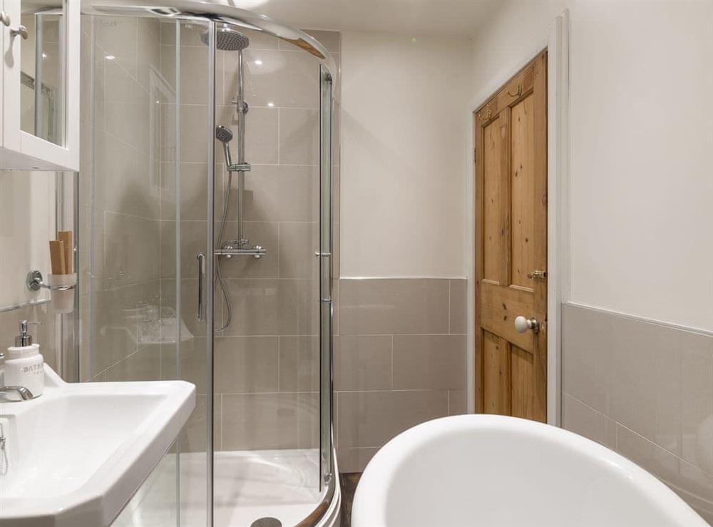 En-suite bathroom with roll top bath & shower at Blackgill Lodge in Grinkle, near Easington, Cleveland