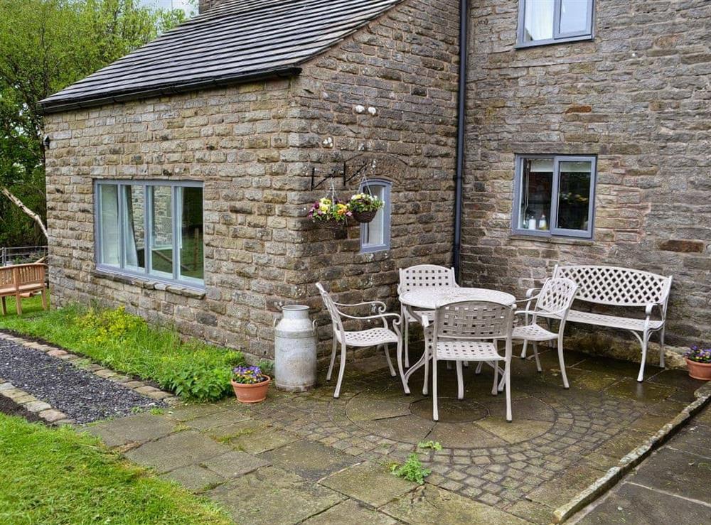 Enclosed lawned garden with furniture and sitting-out-area at Blackhill Gate Cottage in Kettlehulme, near Whaley Bridge, Derbyshire