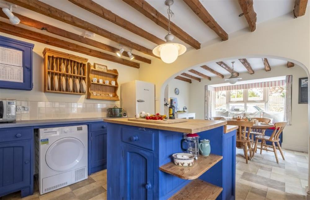 Kitchen with island and dining area at the far end at Blackhorse Cottage, Brancaster Staithe near Kings Lynn