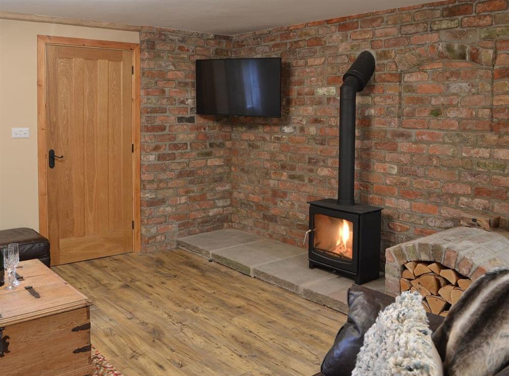 Living room with wood burner at Blacksmiths Cottage in Baswick, near Driffield, North Humberside