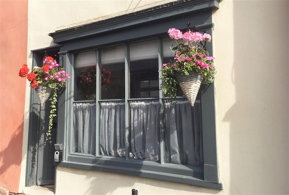 Blacksmith’s Cottage is adorned with colourful hanging baskets at the front of the property at Blacksmiths Cottage, Lavenham
