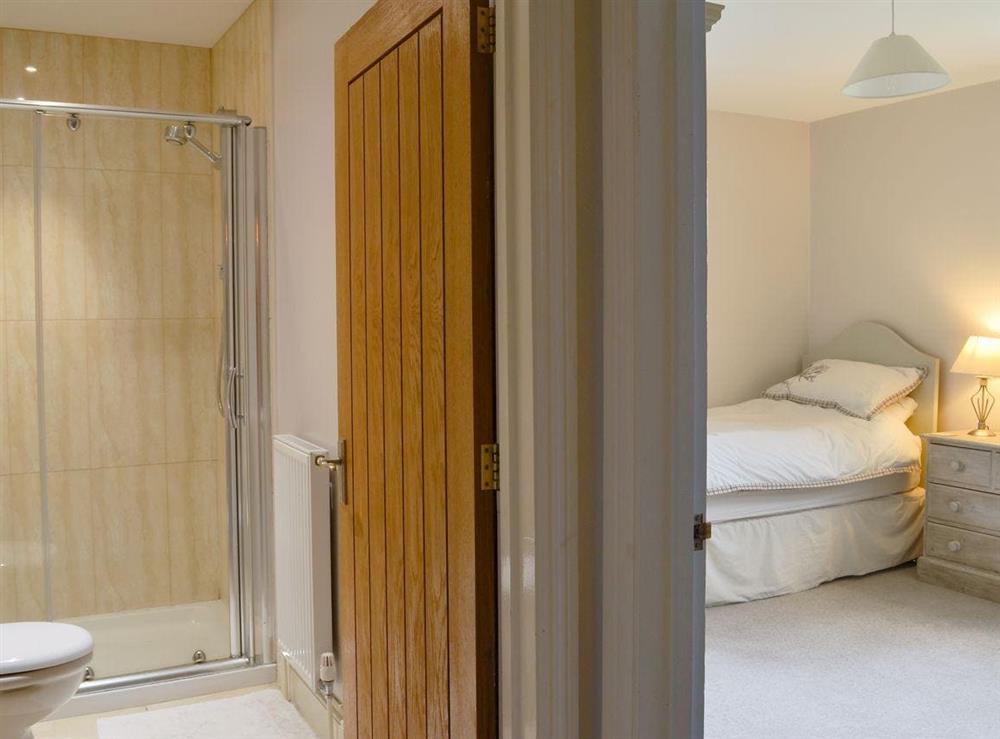 Twin bedroom leading through to shower room at Blackthorn Cottage in Norton Disney, near Newark, Lincolnshire
